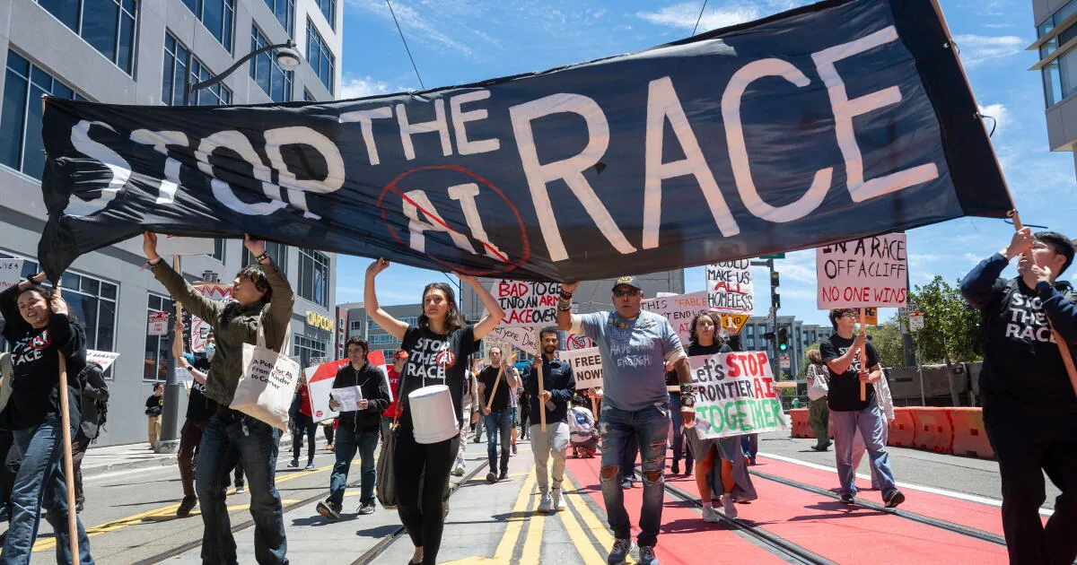 Marchers carry a large ‘Stop the AI Race’ banner down a San Francisco street