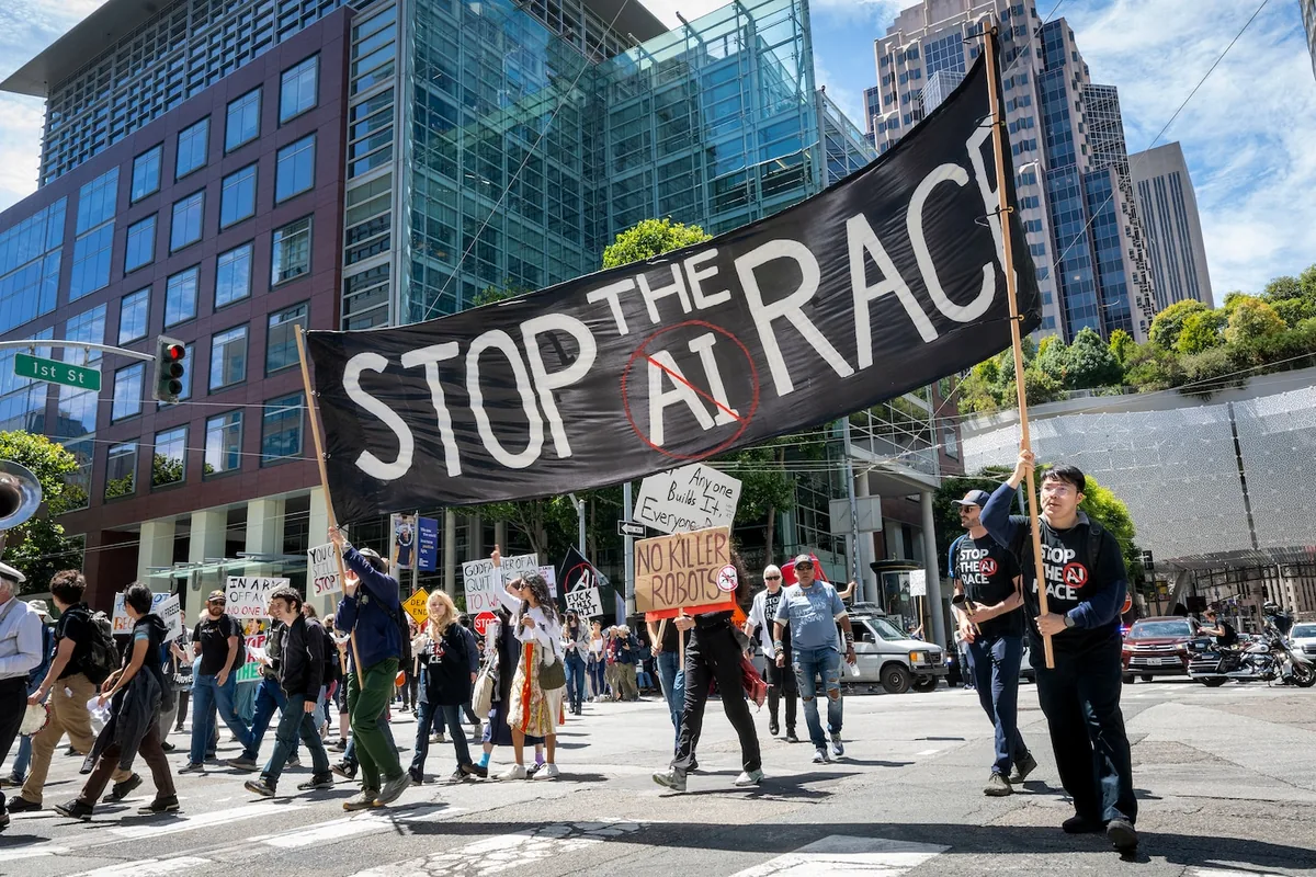 Protesters carry the ‘Stop the AI Race’ banner across a downtown San Francisco intersection